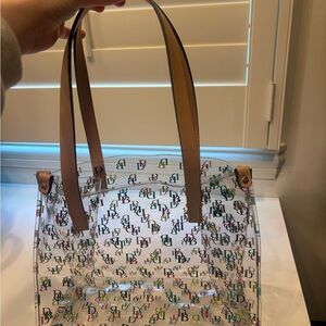 Dooney & Bourke clear tote bag with a multicolor logo pattern